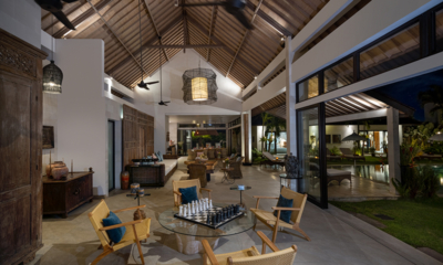 Abaca Villas Villa Iluh Indoor Living Area with Pool View at Night | Seminyak, Bali