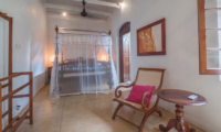 Coconut Grove Bedroom with Mosquito Net and Seating Area | Ahangama, Sri Lanka