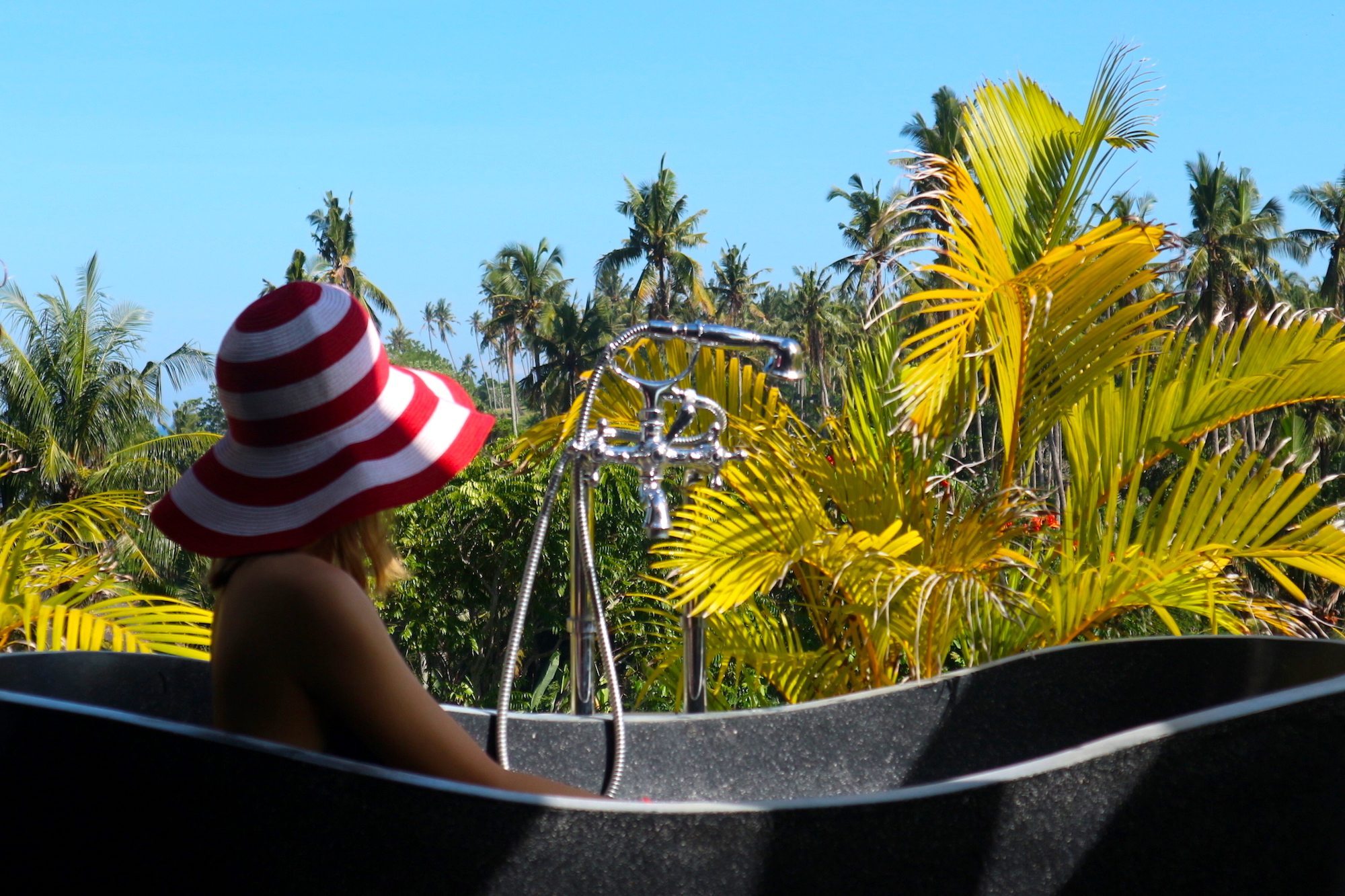 Is this the most beautiful bathtub in Bali? If you're wondering what to do in Bali, be sure to add Tabanan to your travel bucket list. Click through to discover a secret beachfront villa in Tabanan, Bali, Indonesia.