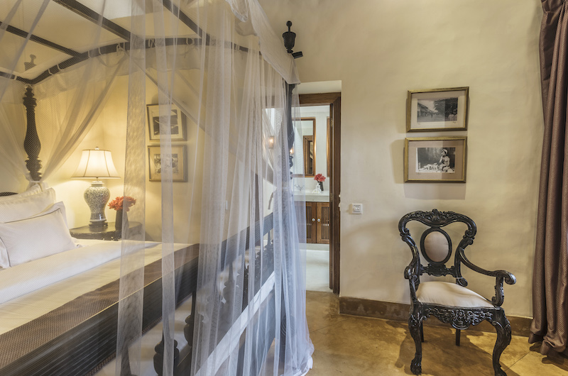 Thambili House Bedroom with Canopy Bed and Chair | Galle, Sri Lanka