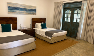 On The Rocks Seventh Bedroom with Twin Beds and Painting | Unawatuna, Sri Lanka