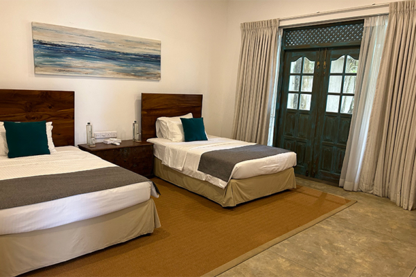 On The Rocks Seventh Bedroom with Twin Beds and Painting | Unawatuna, Sri Lanka