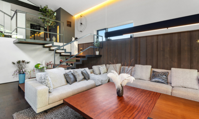 Meikeikyo Hanazono Living Area with Wooden Floor and Up Stairs | Hanazono, Niseko