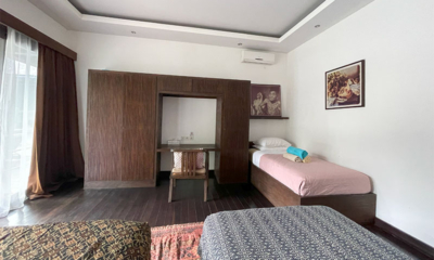 Villa Emile Bedroom with Three Single Beds and a Chair | Uluwatu, Bali